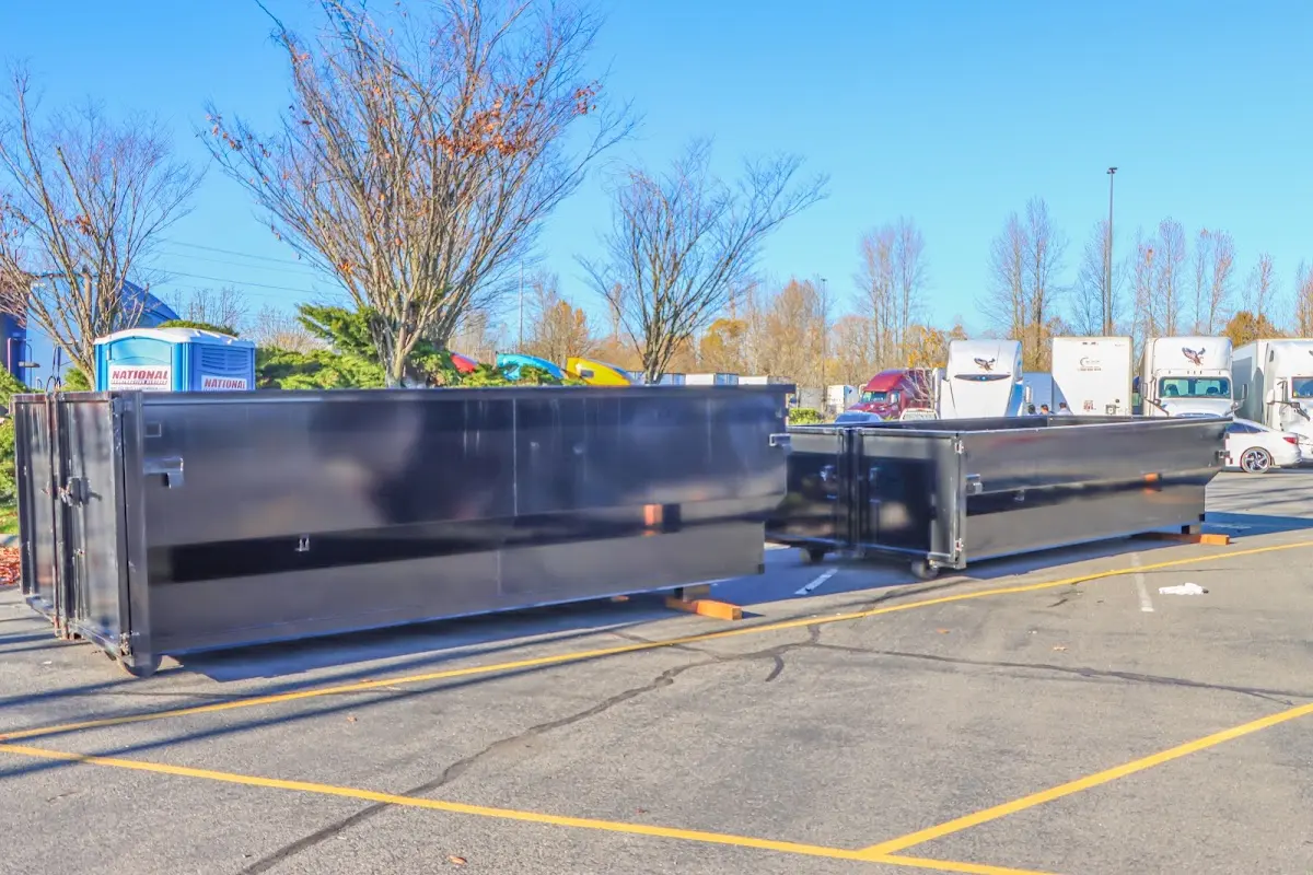 Professional dumpster rental service with roll-off container on residential driveway in Westport